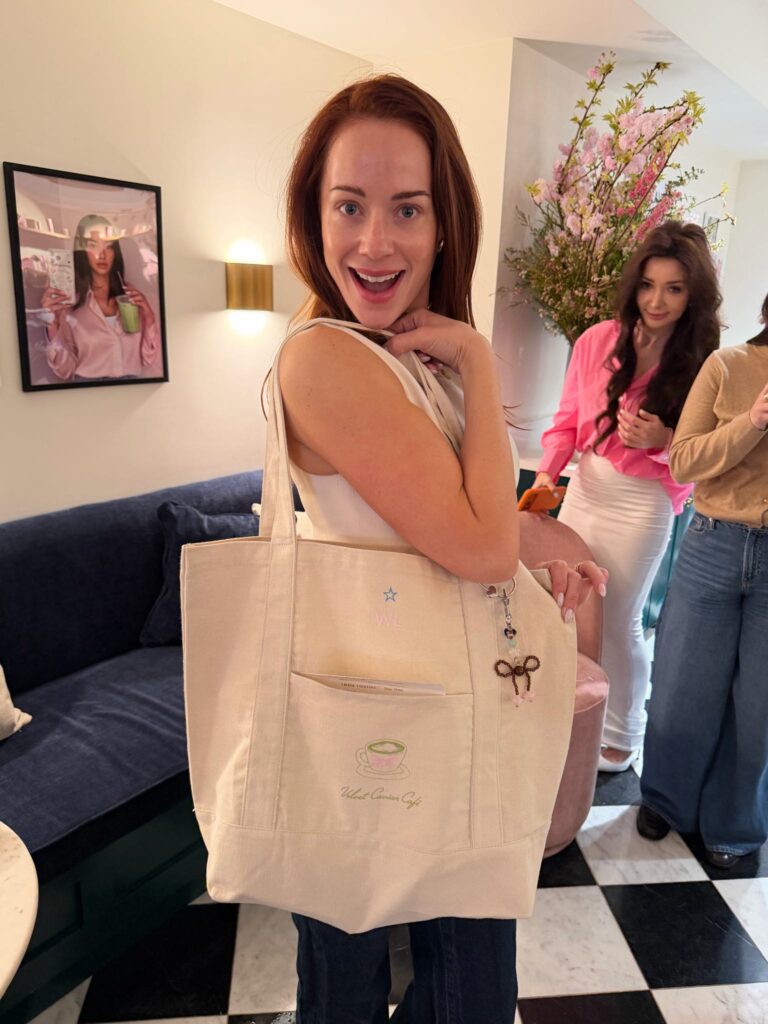 Guest customizing a tote bag at NYES live embroidery event at Velvet Caviar Cafe