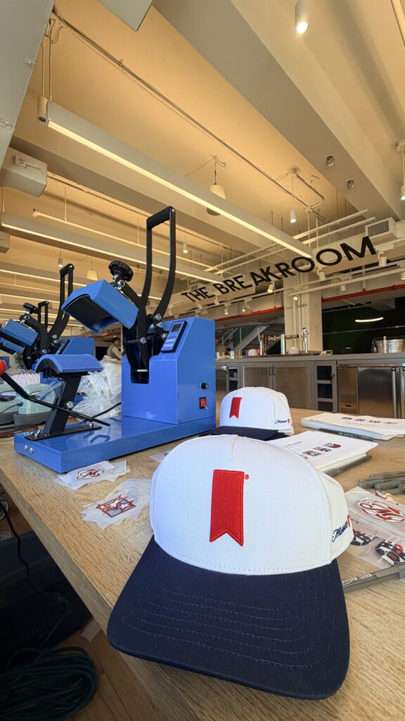 NYES live customization station featuring vinyl hat transfers