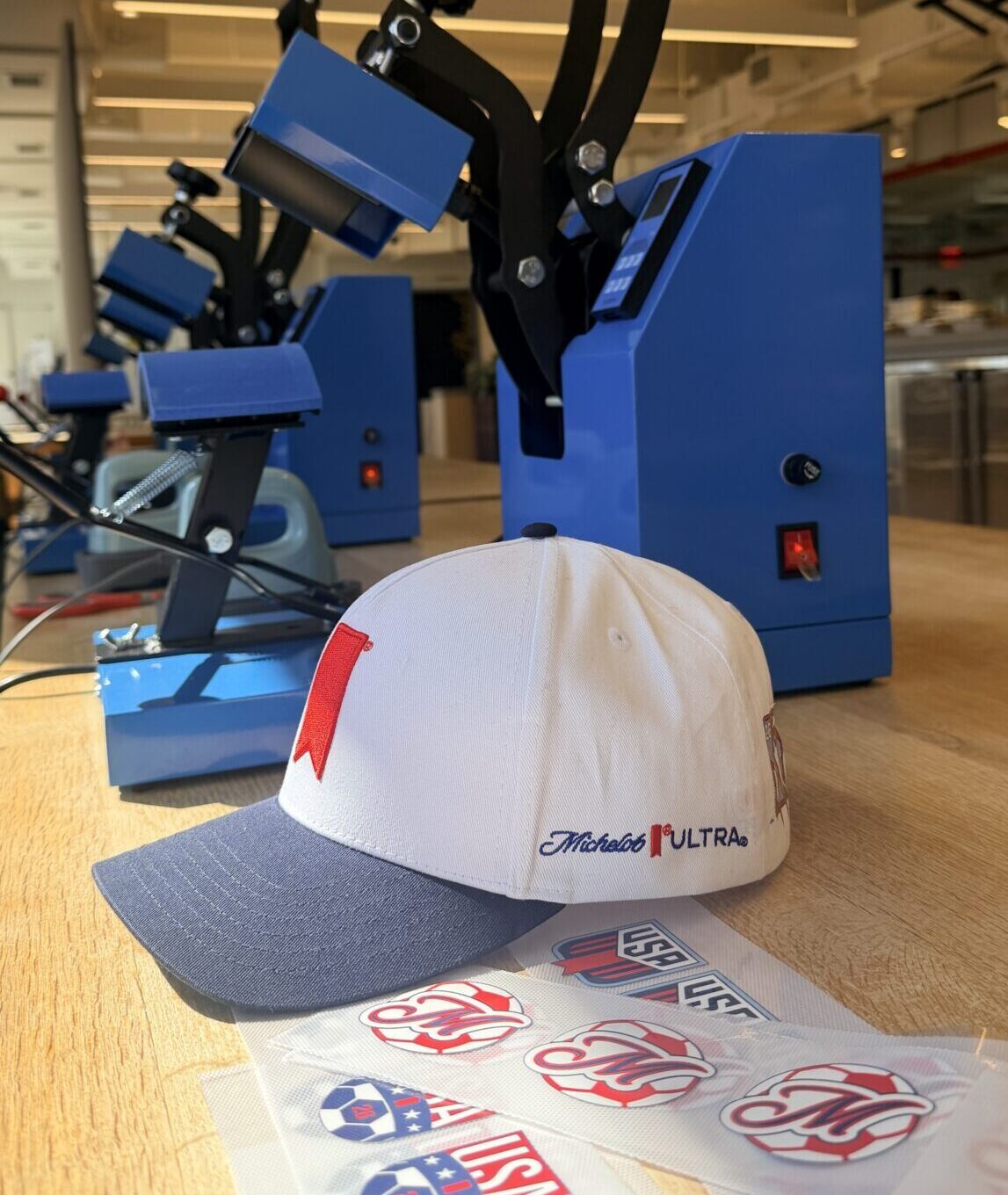 NYES live customization station featuring vinyl hat transfers