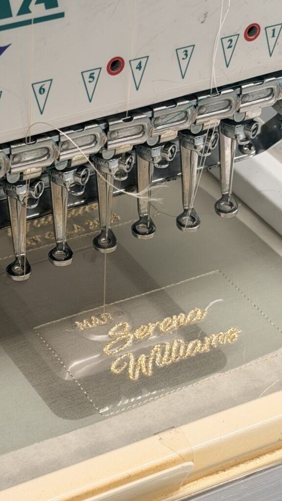 Close-up of custom embroidered fashion label created for a Met Gala 2026 garment