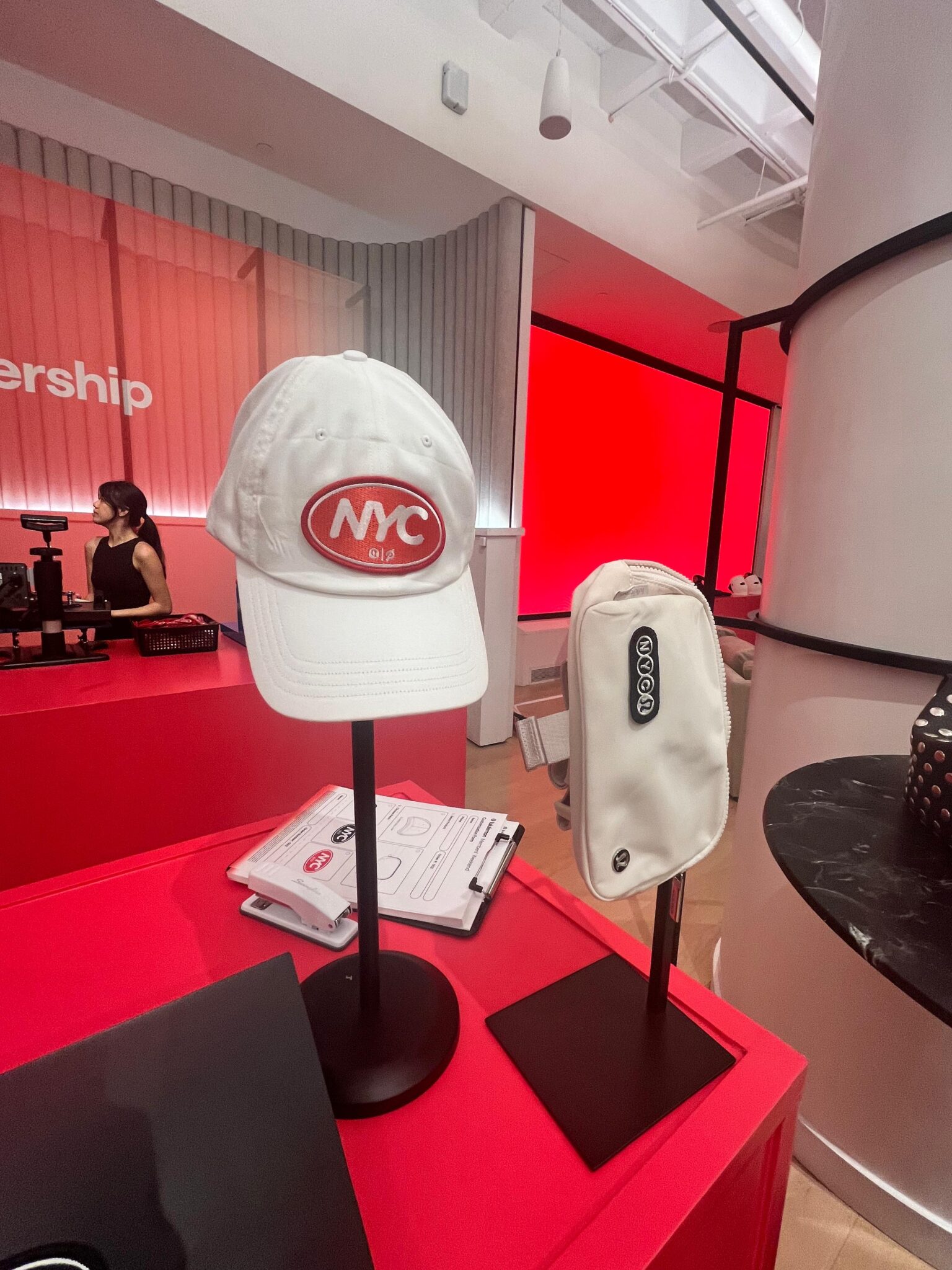 A team member applies custom patches using a heat press at a lululemon experiential event.