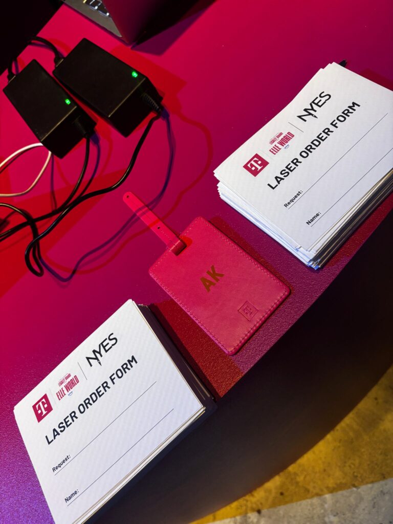 Live laser engraving activation at the T-Mobile x ELLE Women of Impact event, creating personalized gifts for guests during a luxury experiential marketing event.