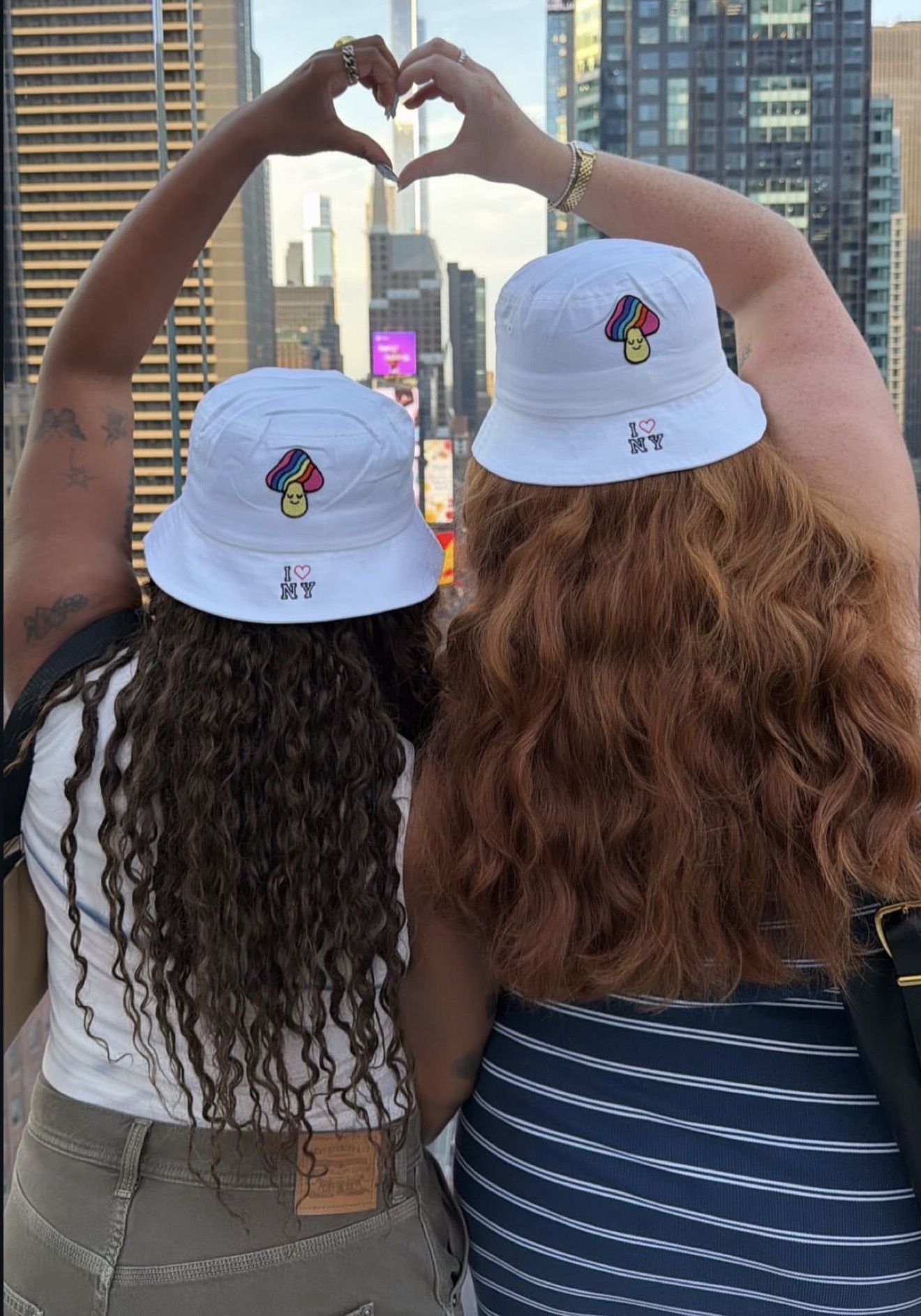 Live embroidery and heat press customization station creating personalized Pride bucket hats and bandanas during the One Times Square Pride celebration.