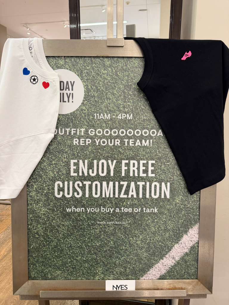 LOFT guests customizing T-shirts and tank tops with heat-pressed graphics during a World Cup-themed retail event.