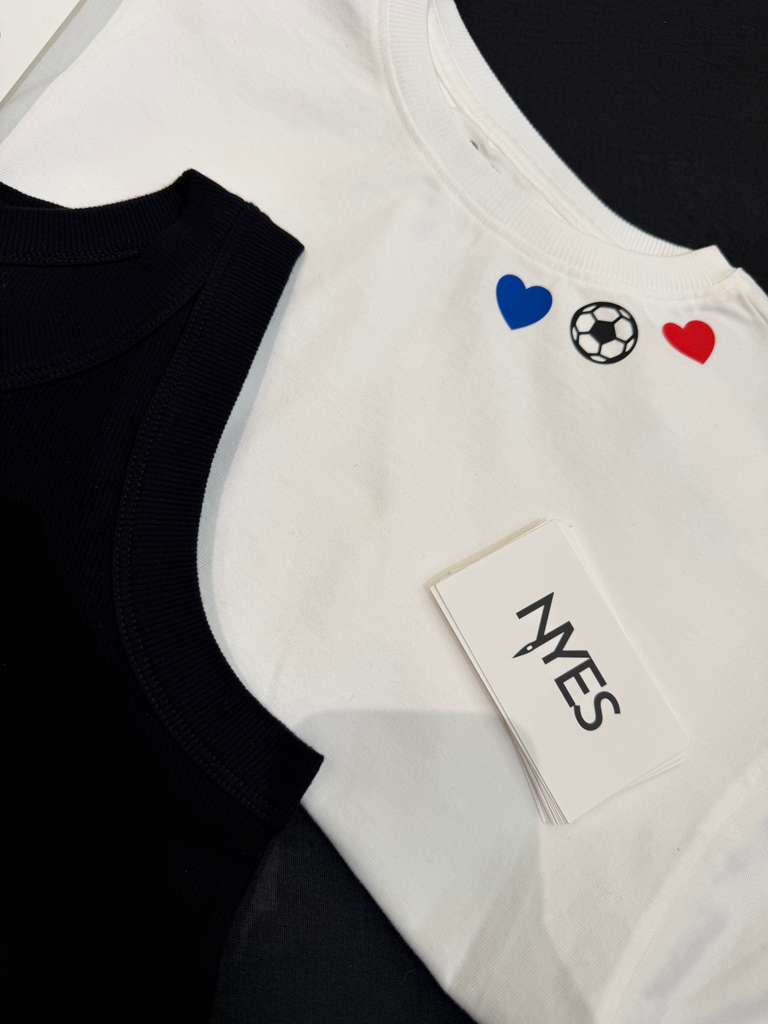 LOFT guests customizing T-shirts and tank tops with heat-pressed graphics during a World Cup-themed retail event.