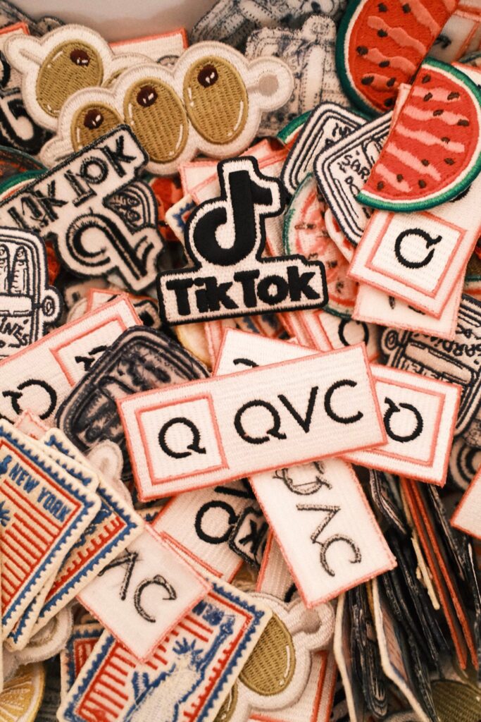 NYES team member heat pressing a custom patch onto apparel during the QVC x TikTok live brand activation.