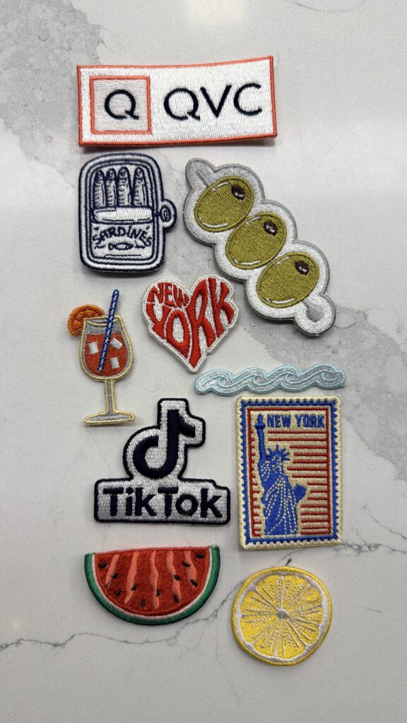 NYES team member heat pressing a custom patch onto apparel during the QVC x TikTok live brand activation.