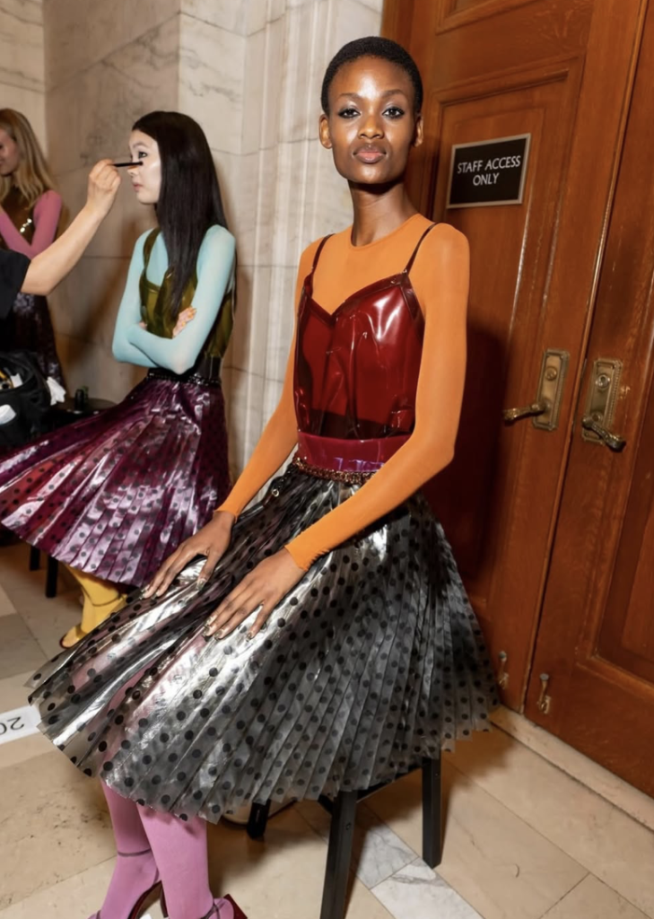 Custom textile printing for Marc Jacobs Spring 2027 runway collection (Look 19). Discover our high-end fashion fabric printing services on pleated garments in NYC.