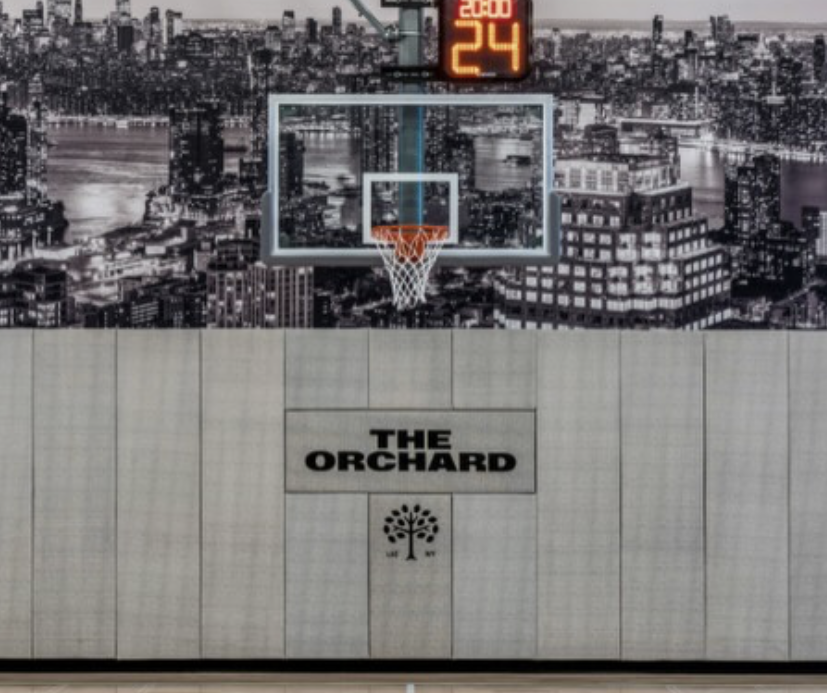 Close-up detail of The Orchard logo embroidered onto Concertex fabric for custom athletic facility wall padding
