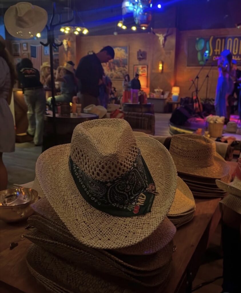 Live embroidery artist stitching a personalized monogram onto a western-style bandana during Gold Bond's interactive customization event.