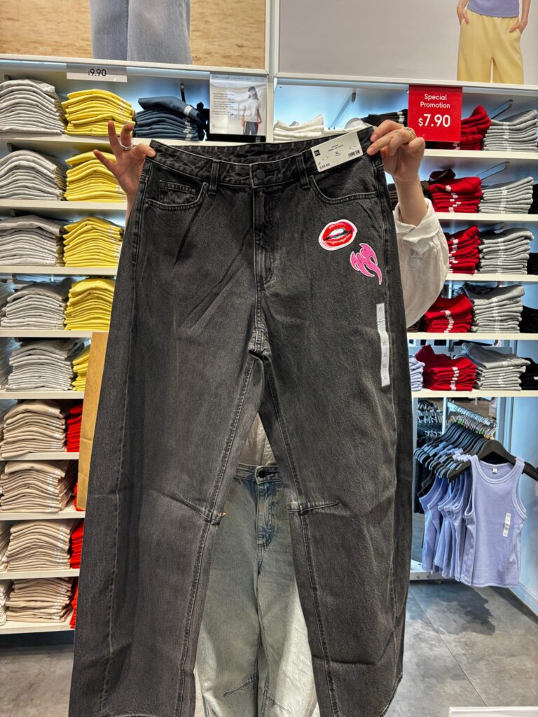 Guest customizing newly purchased GU denim with live embroidery and heat press patches during an interactive in-store activation.