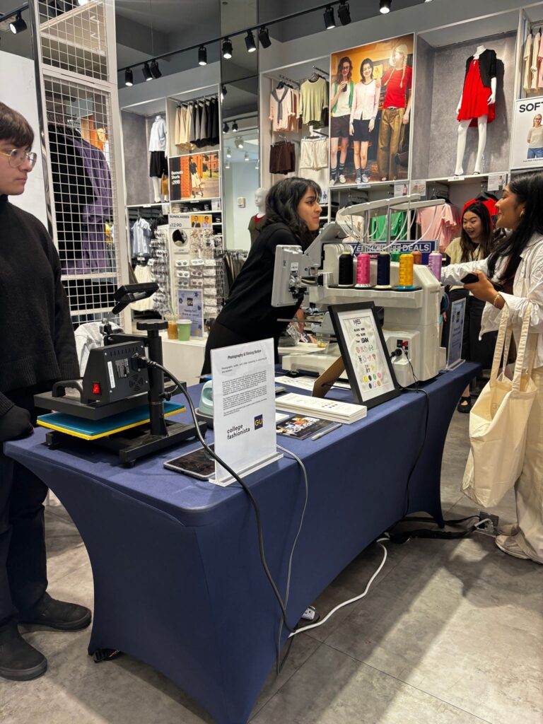 Guest customizing newly purchased GU denim with live embroidery and heat press patches during an interactive in-store activation.
