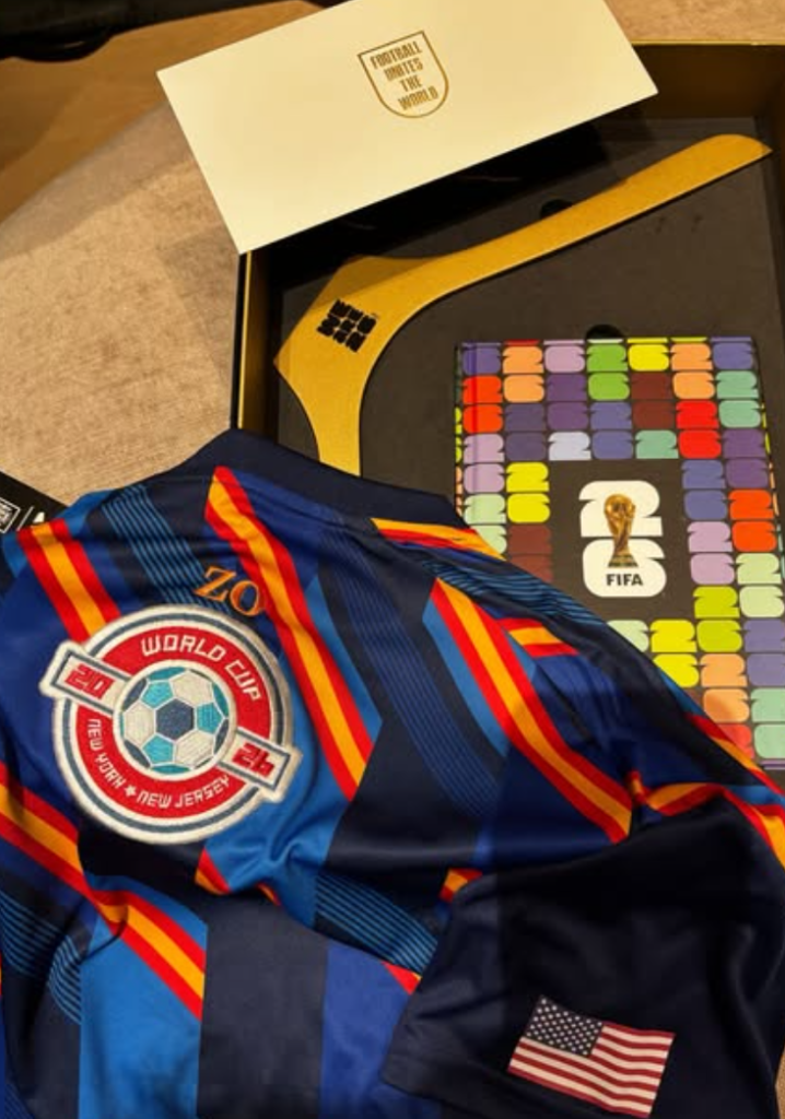 A finished personalized jersey combining NYES-produced embroidered patches with custom guest initials embroidered on-site.