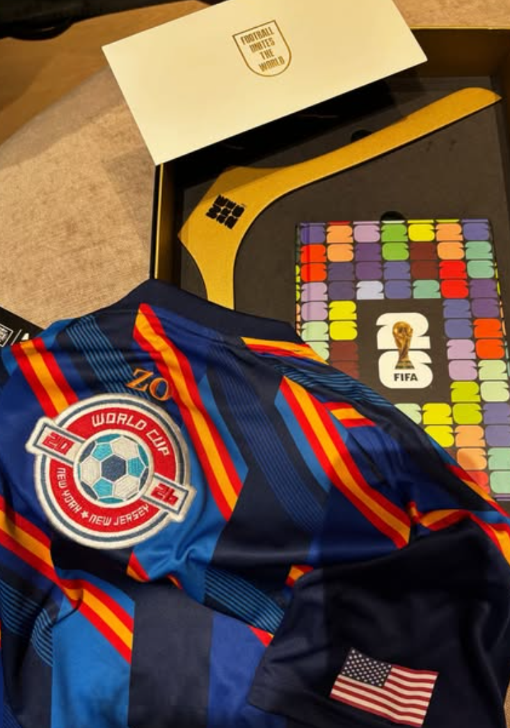 A finished personalized jersey combining NYES-produced embroidered patches with custom guest initials embroidered on-site.