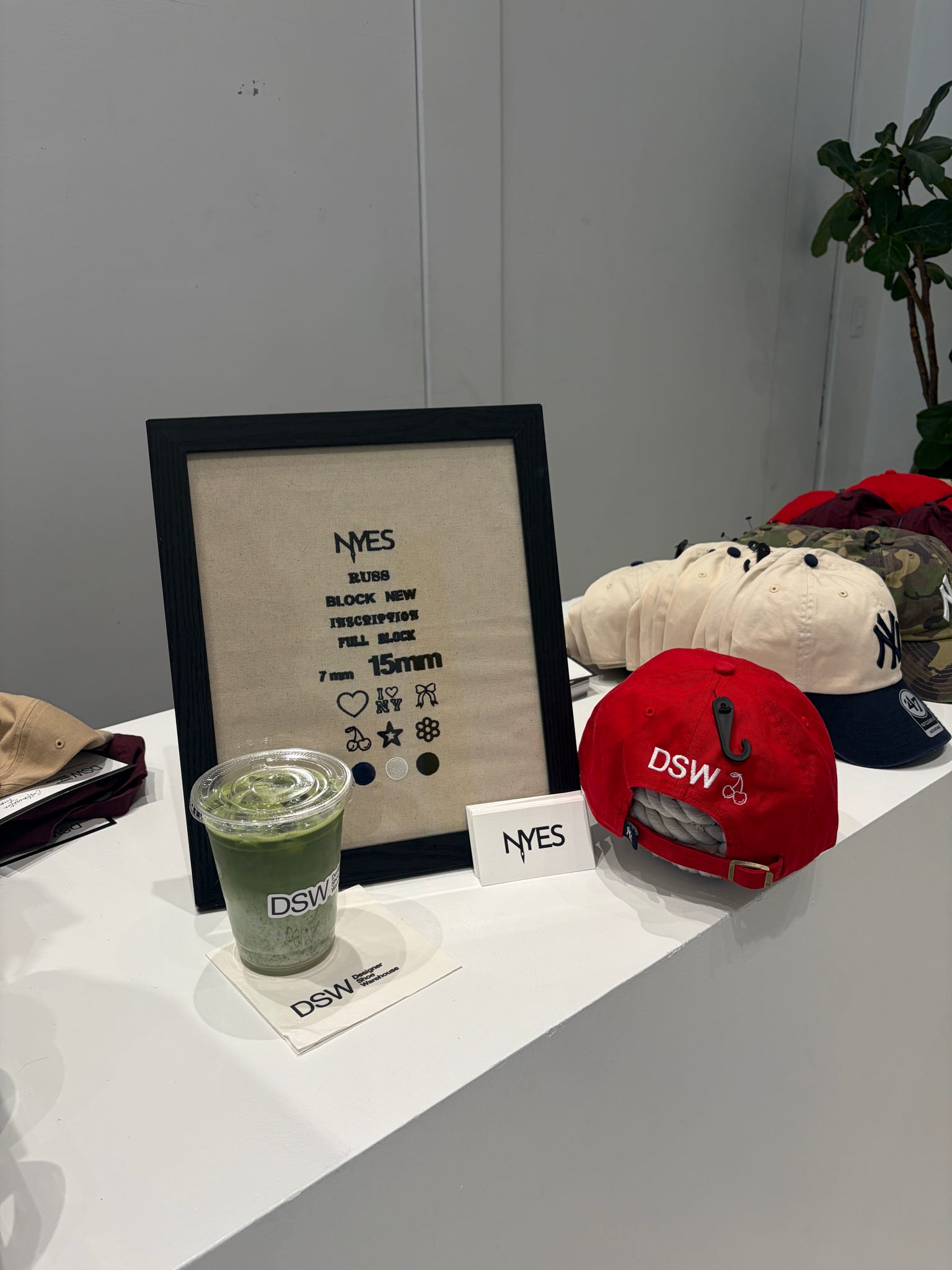 Hat being personalized with live embroidery at a DSW event