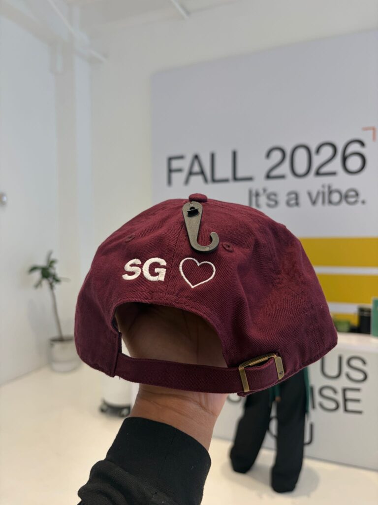 Hat being personalized with live embroidery at a DSW event