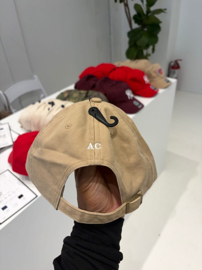Hat being personalized with live embroidery at a DSW event
